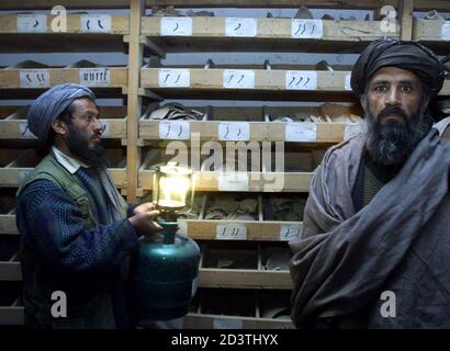 An official at the National Museum in the Afghan capital Kabul holds a lantern to allow journalists to see what is left at the museum March 22, 2001. Afghanistan's Taliban authorities threw open the doors to the museum on Thursday to show they had destroyed all the statues that once formed the heart of the collection.