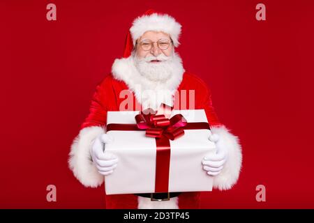 Portrait of his he nice handsome attractive cheerful overweight glad bearded Santa father holding in hands big large white giftbox celebrate isolated