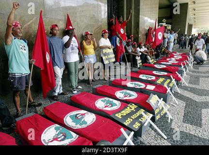A member of Brazil's Landless Movement (MST) chant slogans next to coffins during a demonstration in Rio de Janeiro April 16, 2004, marking the eighth anniversary of a police massacre of 19 rural workers. Landless workers, trade unions and Roman Catholic Church groups have called for a day of protests to remember those killed in the 1996 massacre in which police opened fire on farmers demanding land in the remote in Eldorado dos Carajas, Northeastern Brazil. REUTERS/Sergio Moraes  SM/HB