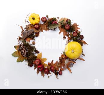 Autumn wreath made from yellow pumpkins and leaves  Stock Photo