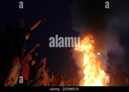 Palembang, Indonesia. 08th Oct, 2020. Demonstrators burn tires as a form of protest against the passing of the Omnibus Law by the Indonesian People's Representative Council in front of the South Sumatra Dewan Perwakilan Rakyat Daerah building Thursday, October 8, 2020. (Photo by Adam Rachman/Pacific Press) Credit: Pacific Press Media Production Corp./Alamy Live News Stock Photo