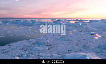 Iceberg from glacier in arctic nature landscape on Greenland. Aerial photo drone footage of icebergs in Ilulissat icefjord. Affected by climate change Stock Photo