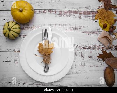 composition with pumpkins and cutlery on an old table Stock Photo