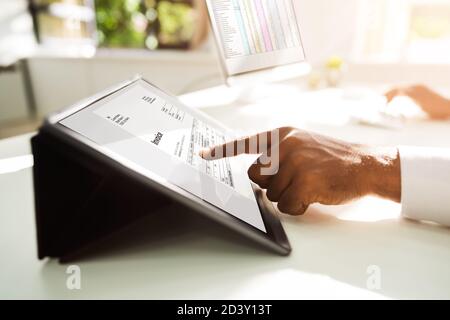 African Advisor Tax Audit Using Invoice Software Stock Photo