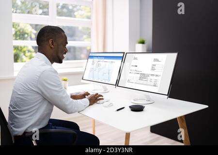 Online Electronic Business Invoice Or Bill. Businessman Looking On Computer Screen Stock Photo
