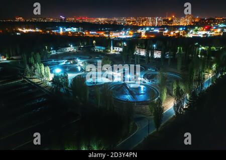 Aerial view at night wastewater treatment plant, filtration of dirty or sewage water. Stock Photo