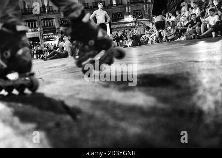 skaters and crowd of tourists and local people enjoying a summer night in Puerta del Sol in Madrid Stock Photo