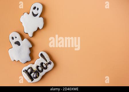 Halloween pattern for postcard. Cheerful funny ghosts and eye are isolated on an orange background. Congratulations on the holiday. Children's food on Stock Photo