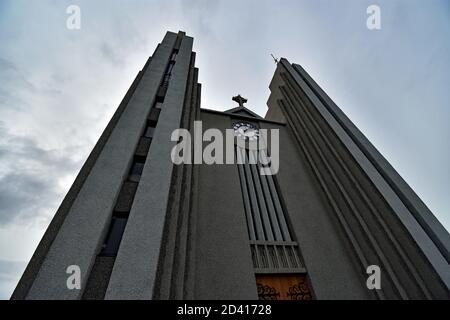 Akureyrarkirkja or the church of Akureyri.  The grey modern building rises dramatically towards the sky.  Northern Iceland. Stock Photo