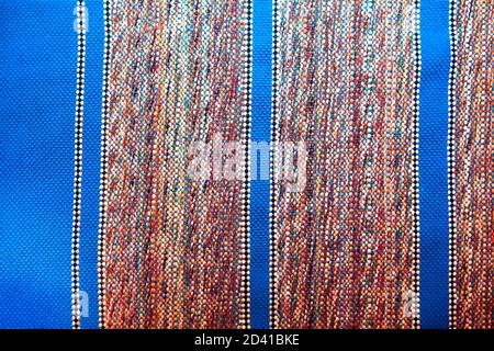 Woven carpet background made of blue and red threads Stock Photo