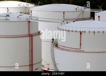 A worker walks up the stairs to an oil storage tank at a fuel and oil storage facility in Berlin August 4, 2004. U.S. oil prices [struck a fresh record high above $44 a barrel August 4, 2004, on continuing concerns that any hiccup in the tightly stretched supply chain could lead to a major disruption in global crude flows. U.S. crude struck $44.28 a barrel, 13 cents up from Tuesday's settlement and the highest since oil futures were launched on the New York Mercantile Exchange in 1983.]