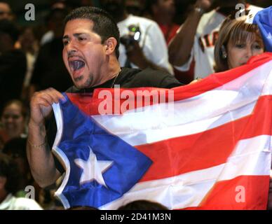 Rolando Montalvo of Aguada, Puuerto Rico yells support for middleweight boxer Felix 'Tito' Trinidad during an official weigh-in at the MGM Grand Garden Arena in Las Vegas, Nevada May 13, 2005. Trinidad (42-1) of Cupey Alto, Puerto Rico takes on Winky Wright (48-3) of St. Petersburg, Florida in a 12-round WBC championship elimination bout at the arena May 14. Both fighters weighed the 160 lb. limit. REUTERS/Steve Marcus  SM