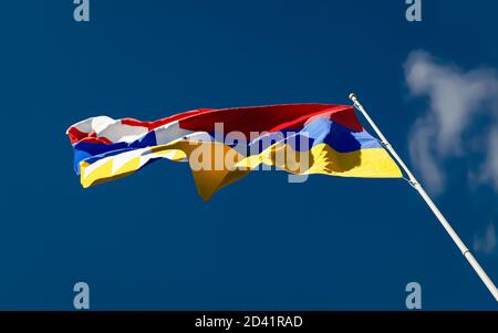 Republic of Artsakh flag waving in the wind low angle. Pride and glory durind Nagorno-Karabakh Armenia Azerbaijan war conflict. Stock Photo