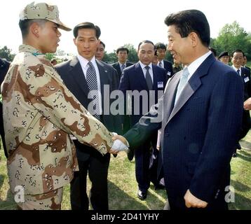 South Korean President Roh Moo-hyun (R) shakes hands with a South Korean soldier bound for Iraq during a farewell ceremony at a military unit in Seoul April 28, 2003. South Korea is to send 673 non-combatants, including a team of engineers and medics, on April 30 to help in the U.S. war effort in Iraq. REUTERS/Choi Jae-ku/Pool  CJK/MC/FA