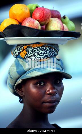 An Angolan vendor sells fruit on the 