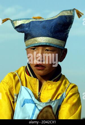 A young Mongolian jockey is seen before a horserace during Naadam Festival at Khui Doloon Khudag village, some 35 kms (22 miles) outside the Mongolian capital Ulan Bator July 12, 2003. About 400 horses, ridden by young jockeys, boys and girls aged between five and 13 years old, competed in the event in a 22 kms distance. Naadam is the biggest event in the Mongolian calendar held on July 11 to 13, marking the anniversary of the Mongolian revolution of 1921.