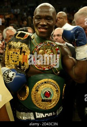 Antonio Tarver of Orlando, Florida (C) poses with belts after defeating WBC light heavyweight champion Roy Jones Jr. of Pensacola, Florida, with a second at Mandalay Bay Center in Las Vegas, Nevada, May 15, 2004. REUTERS ...