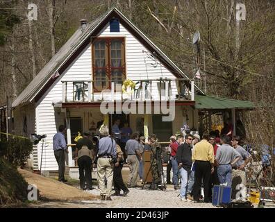 Members of the national and local media camp outside the front door of U.S. Army PFC Jessica Lynch's family home, as they wait to talk with her parents about her rescue and condition, in Palestine, West Virginia, April 2, 2003. U.S. forces rescued Lynch, held captive for ten days and recovered the bodies of at least two other American soldiers in a midnight raid on an Iraqi hospital, officials said Wednesday.  Lynch, 19, had been with a maintenance convoy ambushed by Iraqi forces on March 23. She was rescued from a hospital in the southern Iraqi city of Nassiriya. REUTERS/John Sommers II