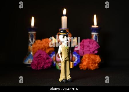 Closeup shot of plastic skulls figurine with a hat for an offering of the day of the dead Stock Photo