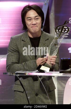 Hong Kong singer and actor Eason Chan shows his award of the best male ...