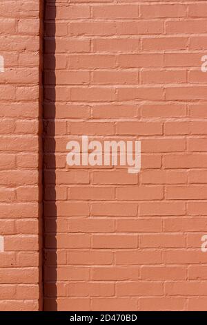 Full frame antique red painted brick wall texture building background in full sunlight with copy space Stock Photo