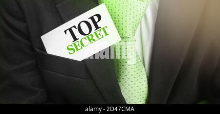 Top secret message on the card in businessman pocket. Confidential information busieness concept Stock Photo