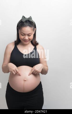 Premium Photo  Young healthy asian pregnant woman in sports bra