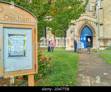 Mourners wait outside the All Saints parish church at Oakham, Rutland, England, for a funeral service during the coronavirus epidemic, October 2020. Stock Photo