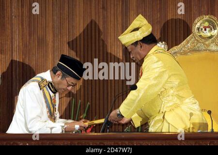 Malaysia's King Syed Sirajuddin (R) receives a scroll containing 