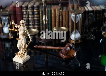 Law and justice concept. Gavel of the jugde, Themis sculpture and scale of justice in the court library. Stock Photo