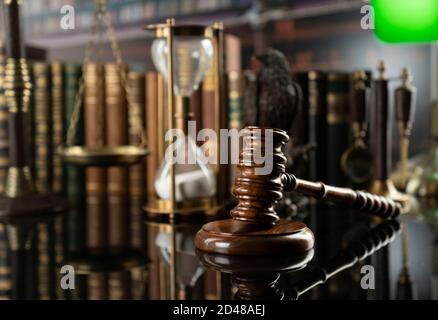 Law and justice concept. Gavel of the jugde, Themis sculpture and scale of justice in the court library. Stock Photo