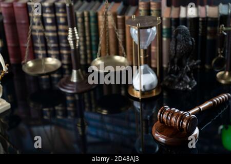 Law and justice concept. Gavel of the jugde, Themis sculpture and scale of justice in the court library. Stock Photo