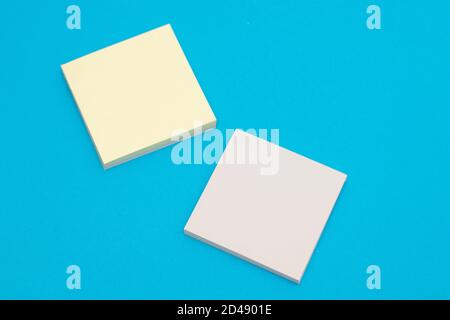 Stack of yellow paper stickers on blue background Stock Photo