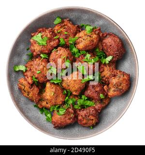 Veg Pakora in gray bowl isolated on white. Pakoda is indian cuisine appetizer deep fried dish. Asian food and meal Stock Photo