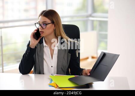 Successful relaxed dreamy businesswoman lawyer resting at her workplace Stock Photo