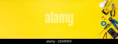 Electriciantools on a yellow background. Banner with space for text Stock Photo