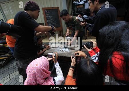 the photographers are taking pictures of the drink and food menu on the cafe page. behind the scenes activities with a food photographer. pasuruan, In Stock Photo
