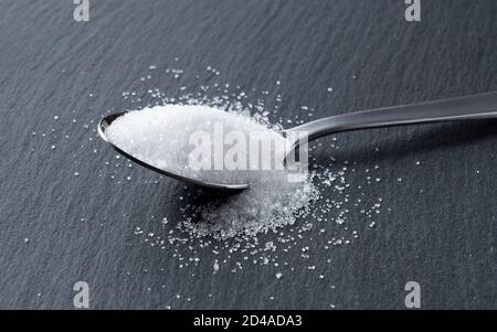 Sugar placed on a black stone plate Stock Photo
