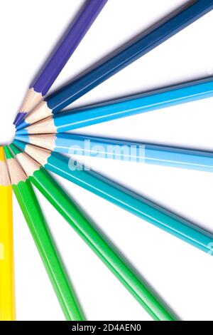 a semicircle of blue and green sharp pencils on a white background Stock Photo