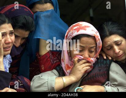 Relatives weep over the killing of Mukhtar Ahmad, a pro-India politician, in Srinagar March 18, 2004. Suspected Muslim rebels on Thursday shot dead Ahmad, a senior member of Janata Dal, a pro-India political party, outside his home in Srinagar, the summer capital of troubled Jammu and Kashmir, police said. REUTERS/Danish Ismail  AH/CP