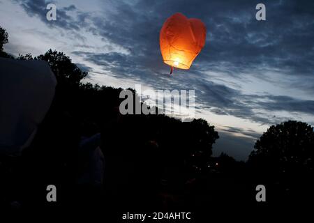 Sky lanterns released into the night sky in a commemorative celebration of life in Kent, UK Stock Photo