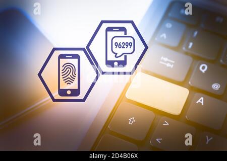 Two Hexagon Icons symbolising Secure Authetication in Front of a Smartphone and a Laptop Computer Stock Photo