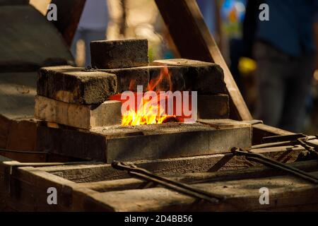 a burning forge made of bricks in nature Stock Photo