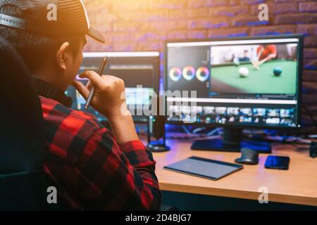 Asian creative man and editor video work Vlogger editing video create content for upload on social media or internet online connect communication peop Stock Photo