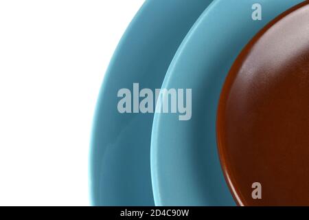 Set of three plates isolated on white background. Ceramic plates in blue and brown colors, abstract background for desing. Close-up photo of ceramic d Stock Photo