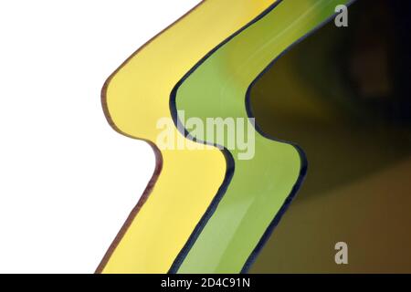 Abstract plastic background in yellow, green and brown colors. Close-up photo of plastic lenses for sunglasses Stock Photo