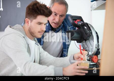 student in carpentry class using circular saw Stock Photo