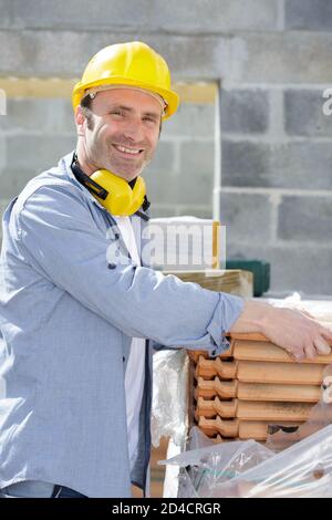happy masonry construction worker in construction site Stock Photo