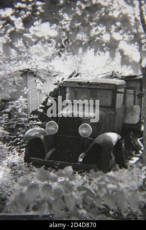 Fine 1970s vintage black and white photography of a vintage Model T Ford truck found in the junk pile behind the shed. Stock Photo