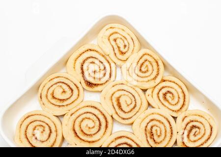 Buns with cinnamon and sugar on baking dish. Top view Stock Photo